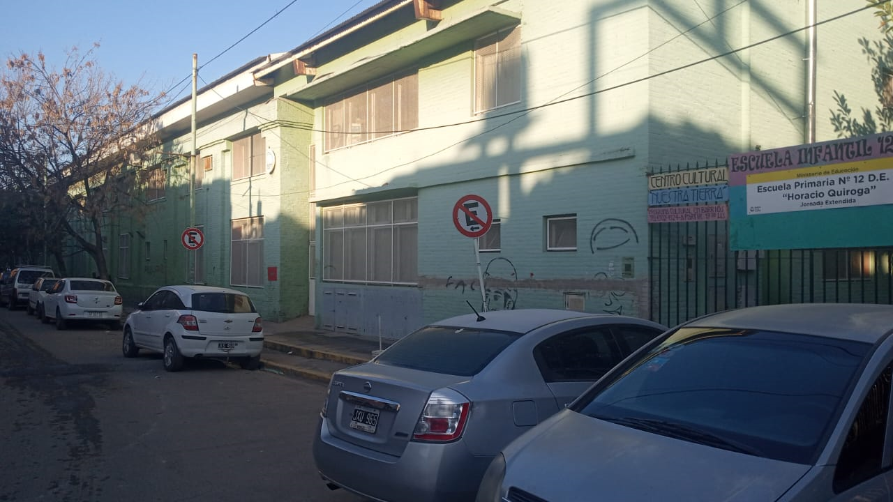 Cars parked in front of a building  Description automatically generated